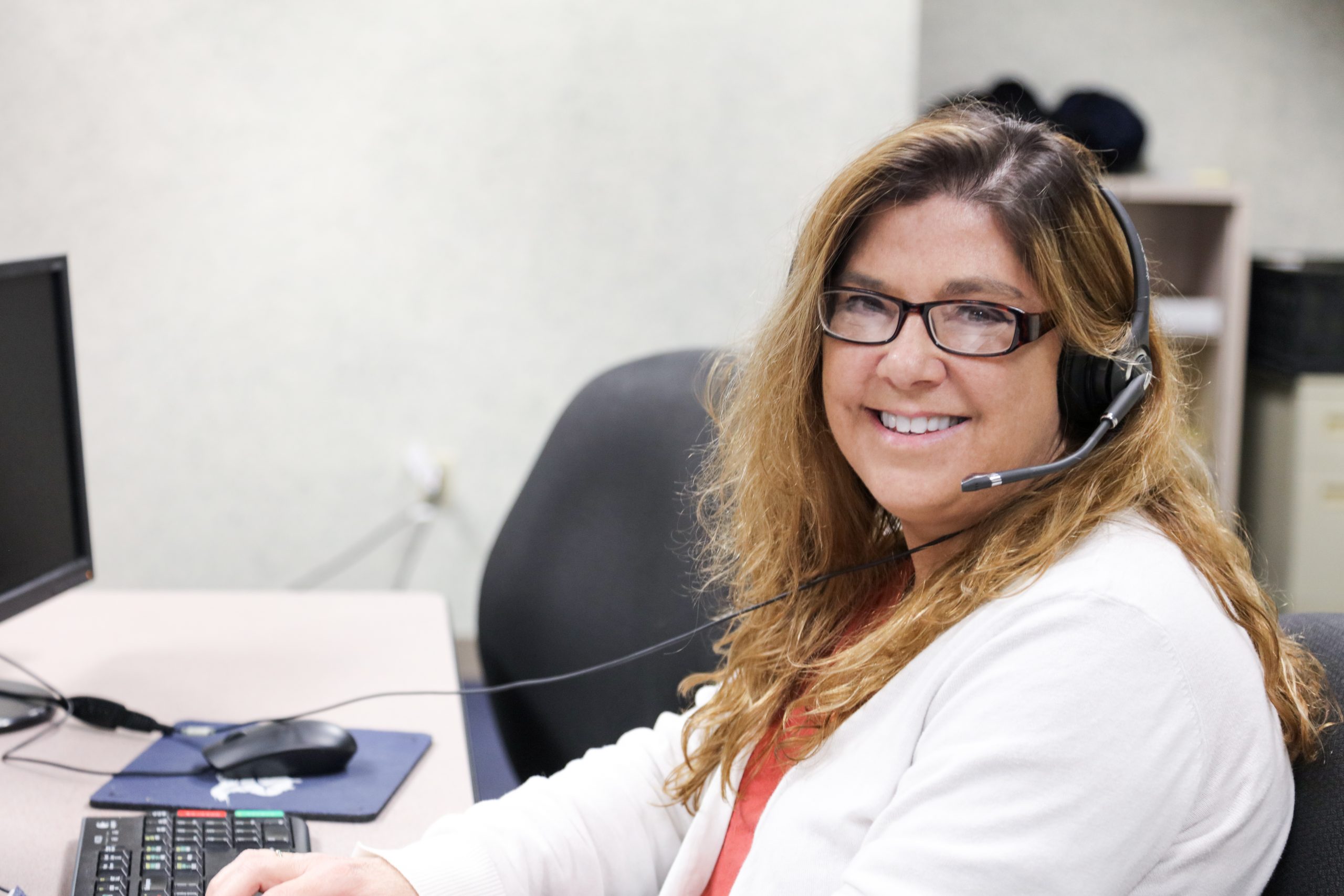 Female Call Center Agent happy to take your call